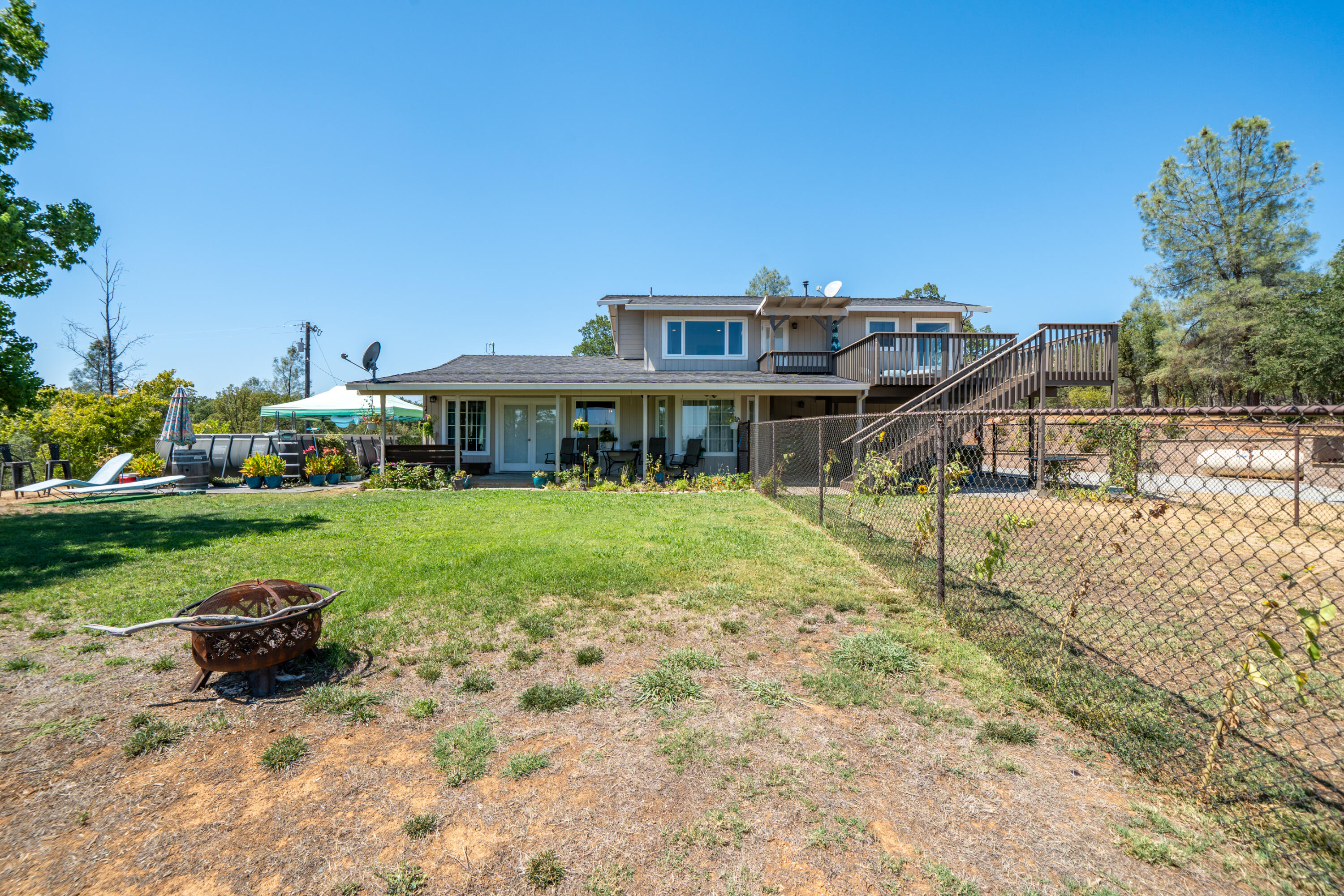 7954 Placer Road Redding, CA 96001 - Photo 46 of 97 a view of a house with backyard porch and sitting area