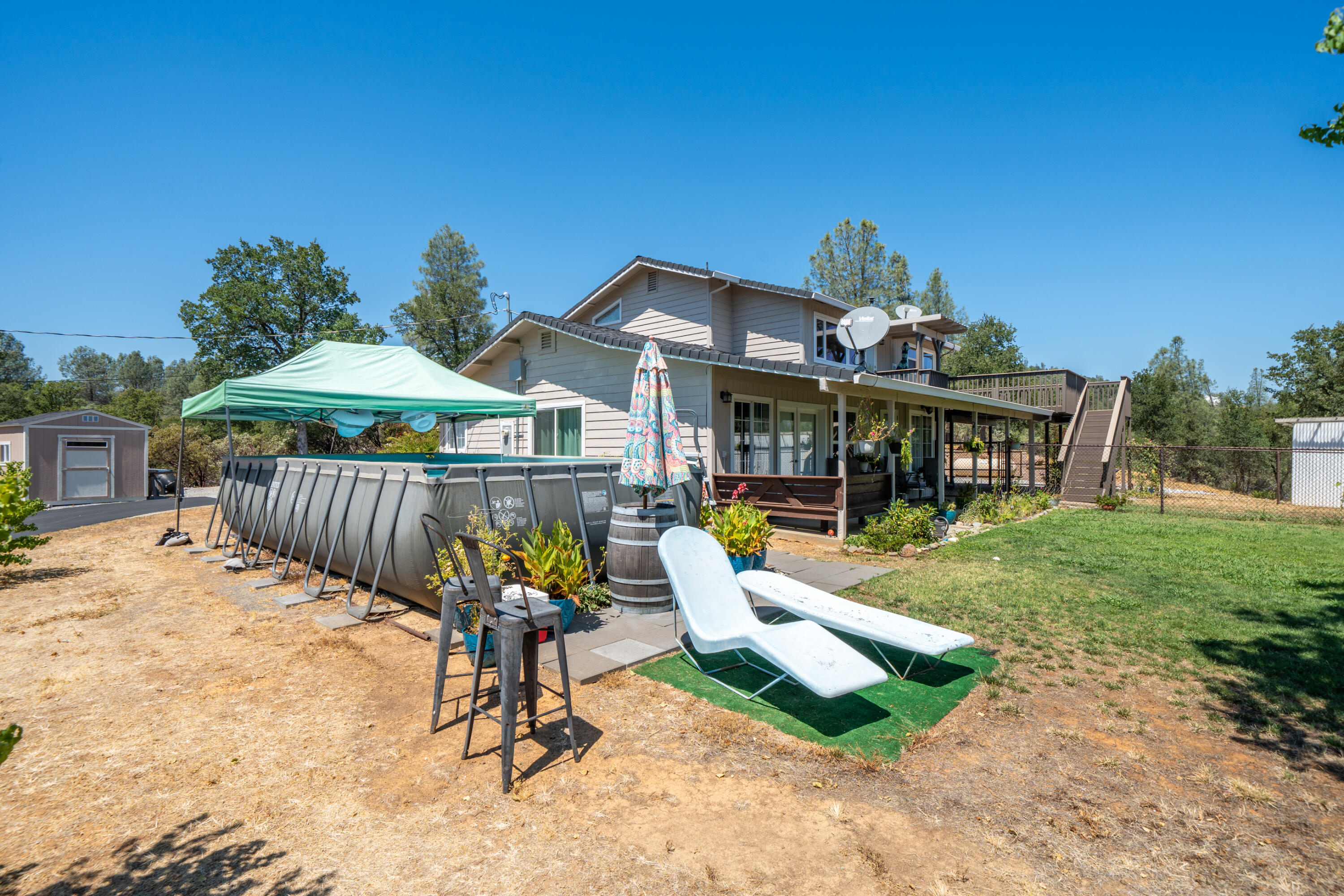 7954 Placer Road Redding, CA 96001 - Photo 51 of 97 a view of a house with backyard and porch