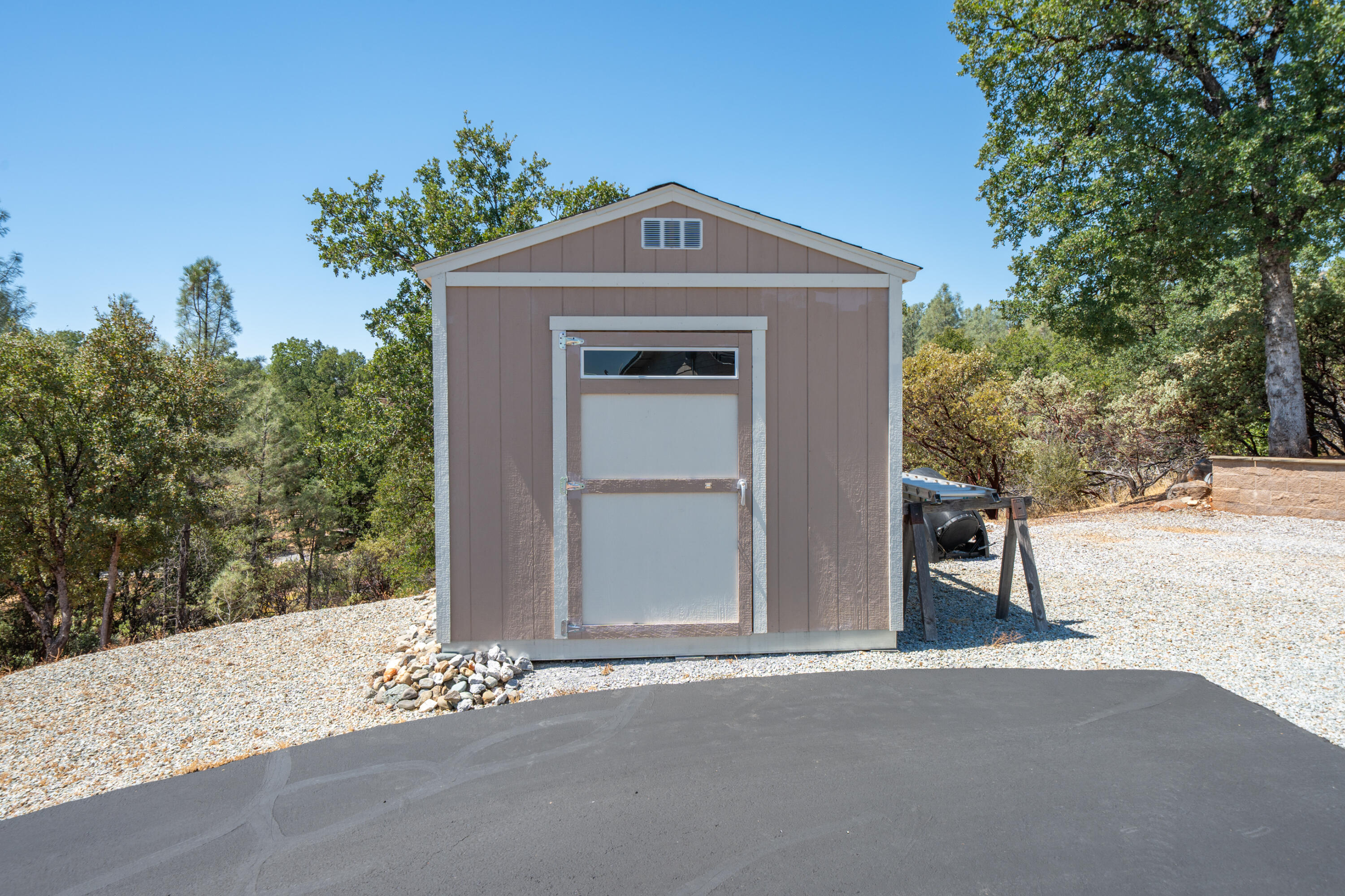 7954 Placer Road Redding, CA 96001 - Photo 61 of 97 a front view of a house with a yard and garage