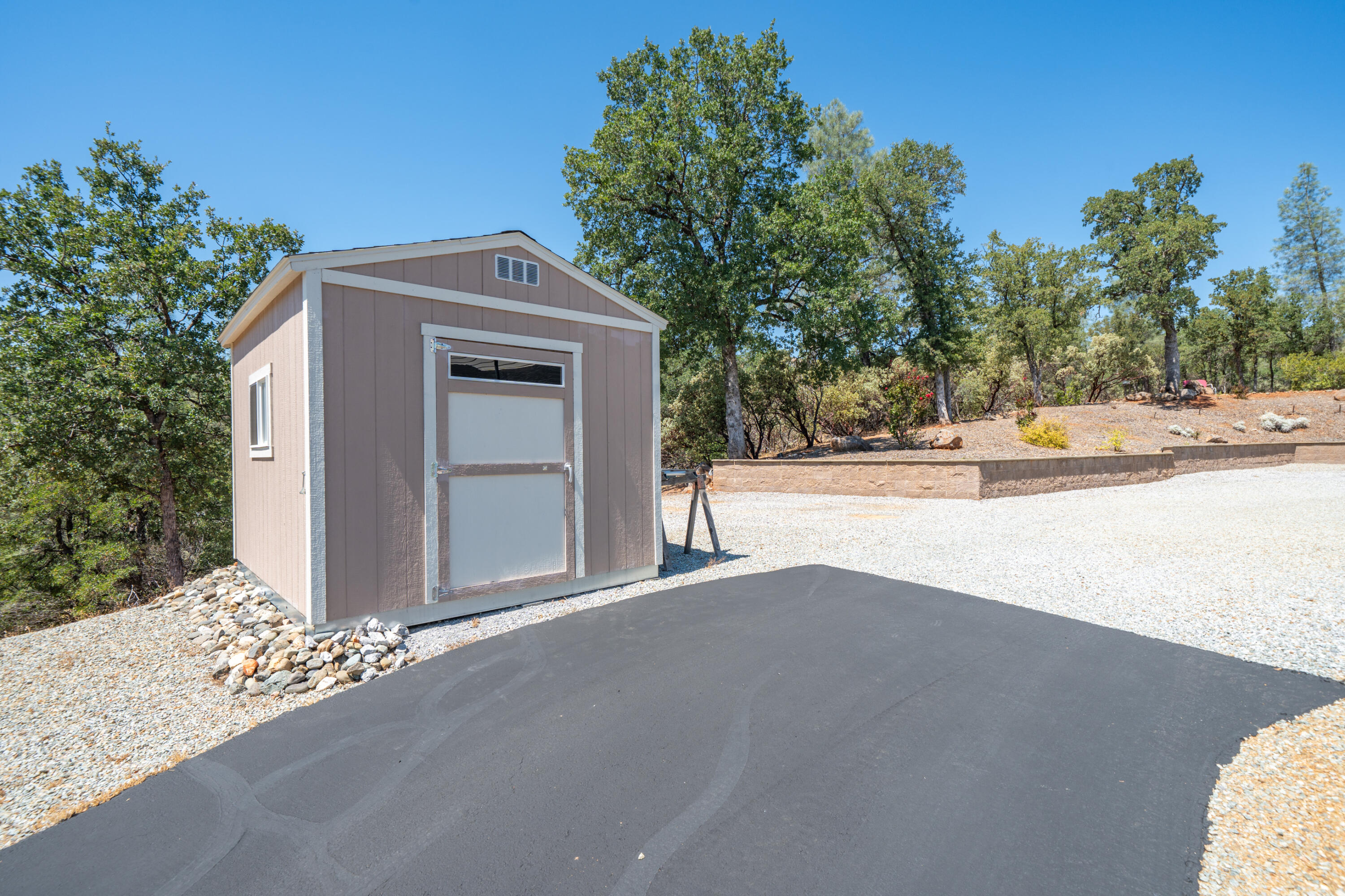 7954 Placer Road Redding, CA 96001 - Photo 62 of 97 a front view of a house with a yard and garage