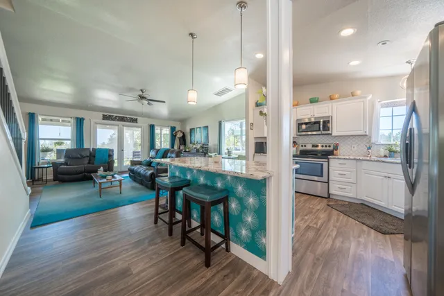 a dining room with furniture and wooden floor