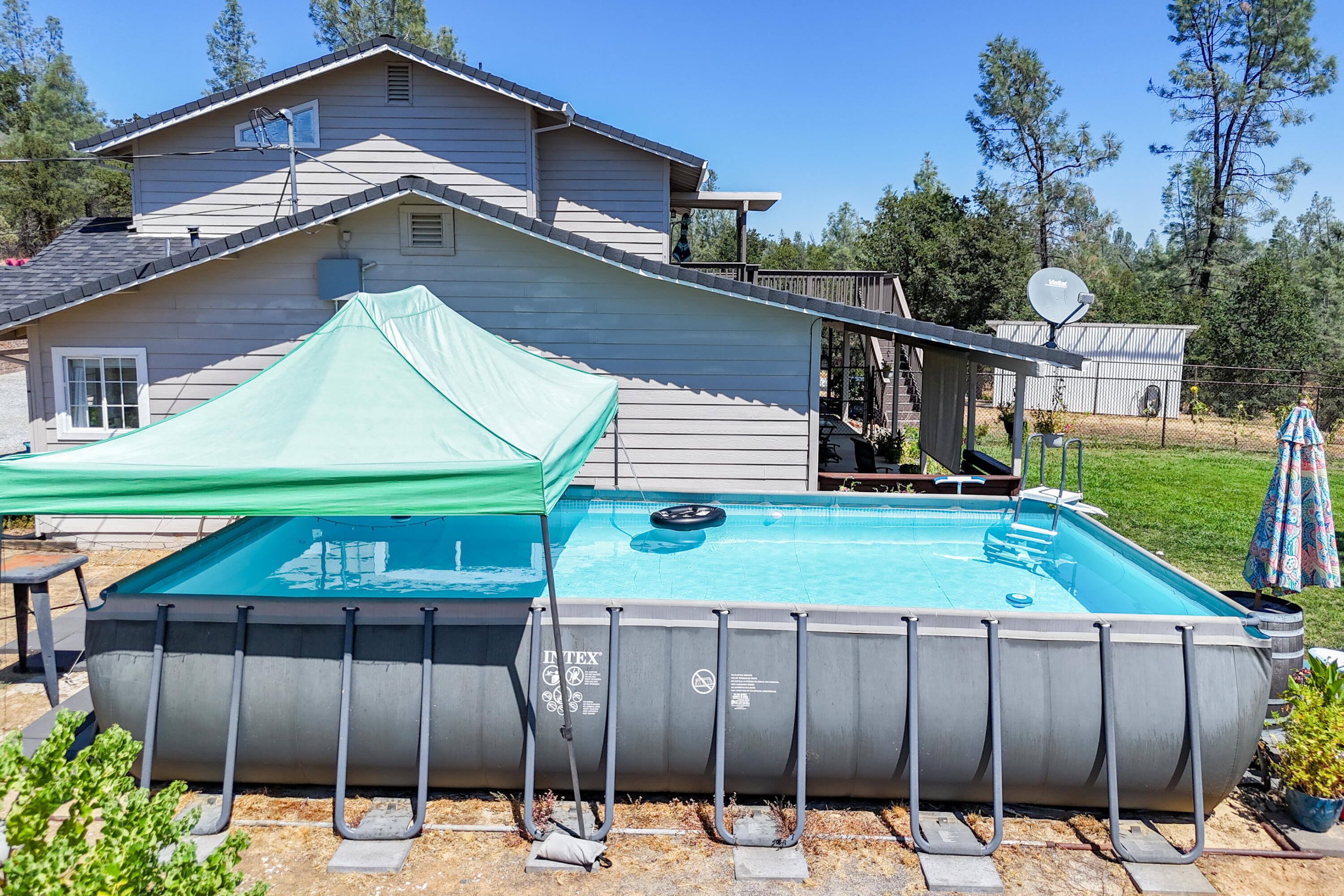 7954 Placer Road Redding, CA 96001 - Photo 94 of 97 a backyard of a house with barbeque oven table and chairs