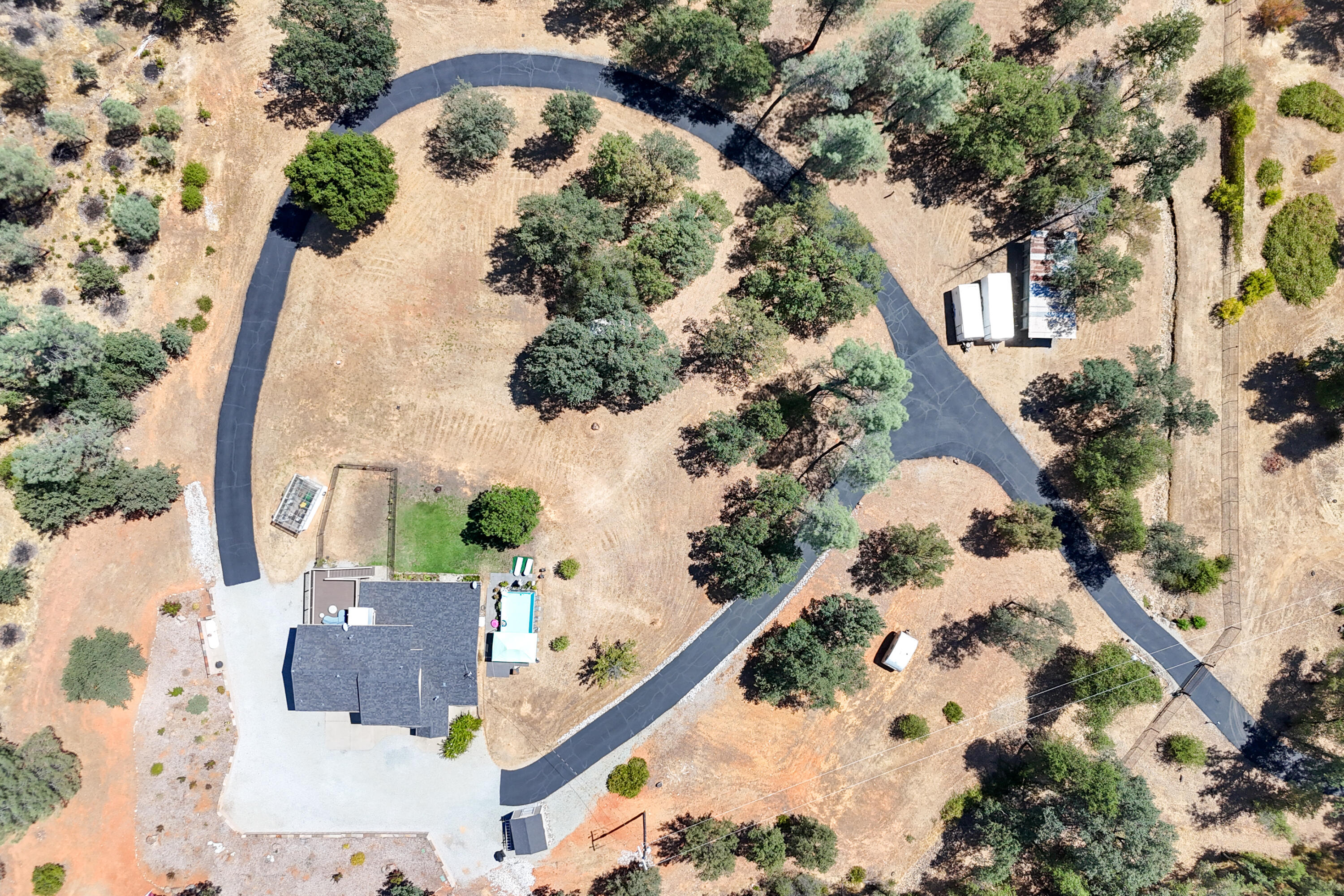 7954 Placer Road Redding, CA 96001 - Photo 95 of 97 an aerial view of a house with a yard and a wooden deck