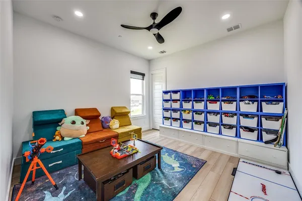 a living room with furniture and a book shelf