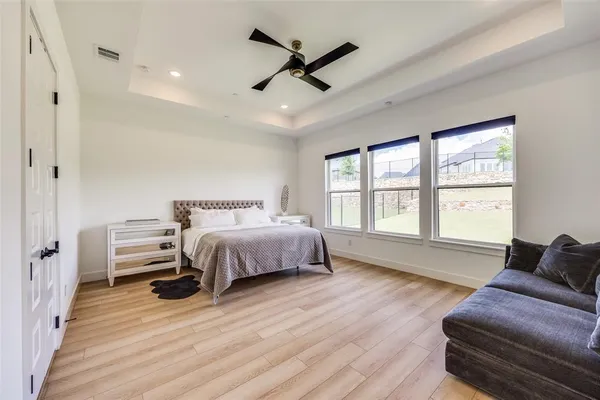 a spacious bedroom with a bed and a couch