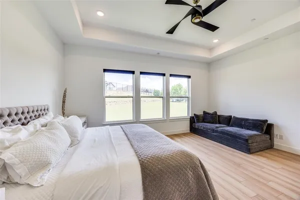 a bedroom with a bed couch and window