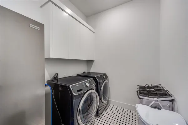 a utility room with sink dryer and washer