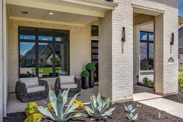 a outdoor living space with furniture potted plant and glass door