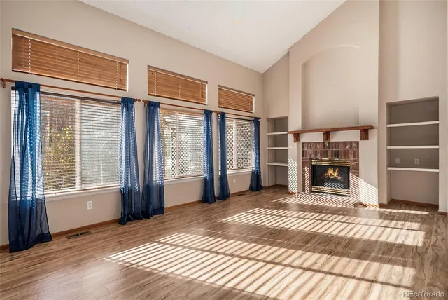 a view of a livingroom with furniture and an empty room