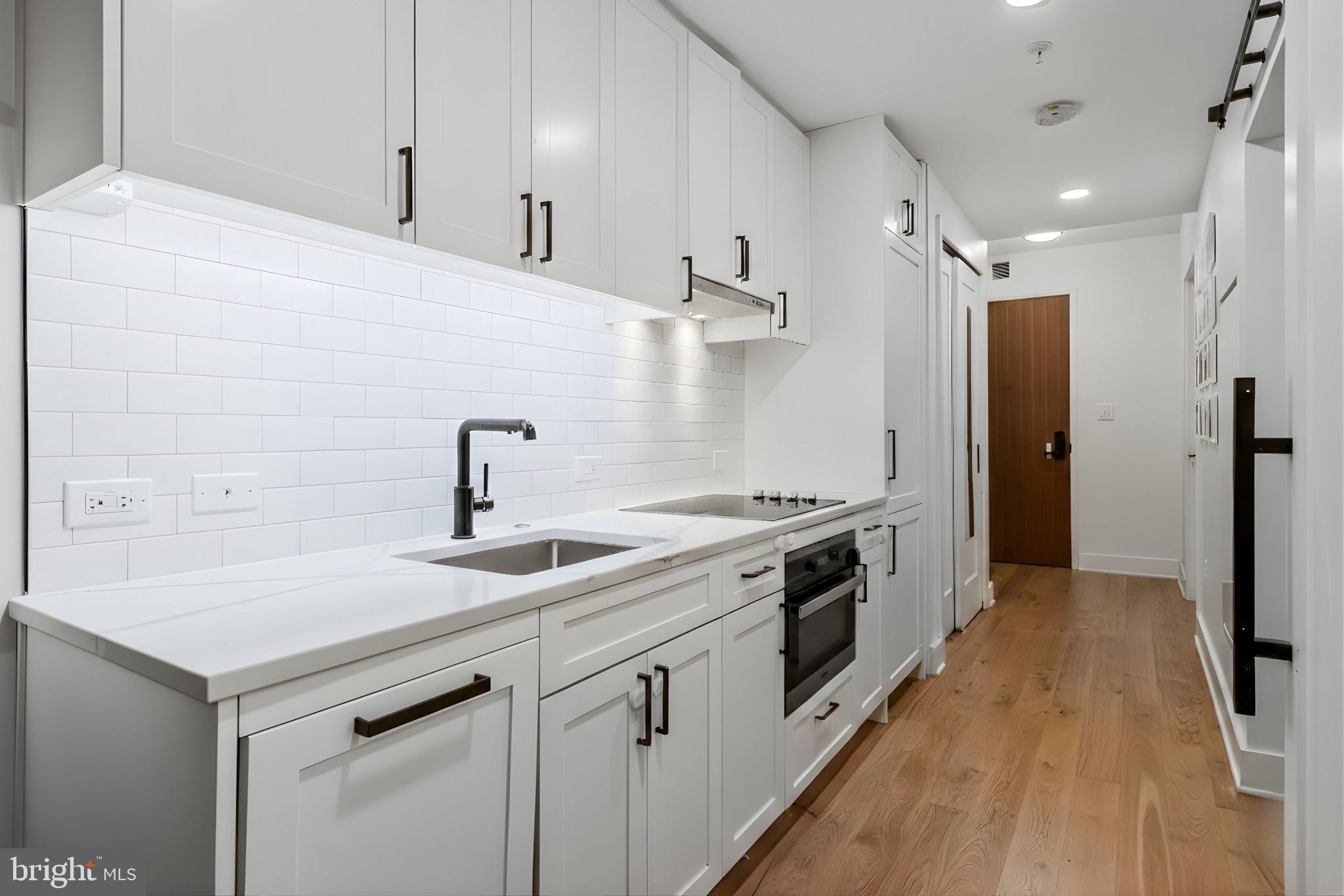 1211 Van Street Southeast, Unit 614 Washington, DC 20003 - Photo 2 of 21 a kitchen with a sink stove and refrigerator