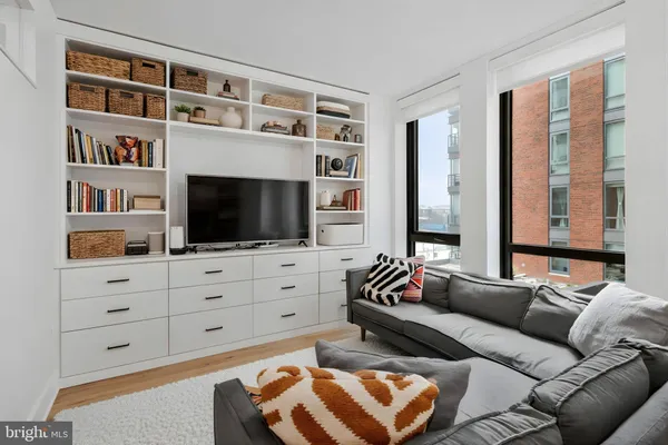 a living room with furniture cabinets and a flat screen tv