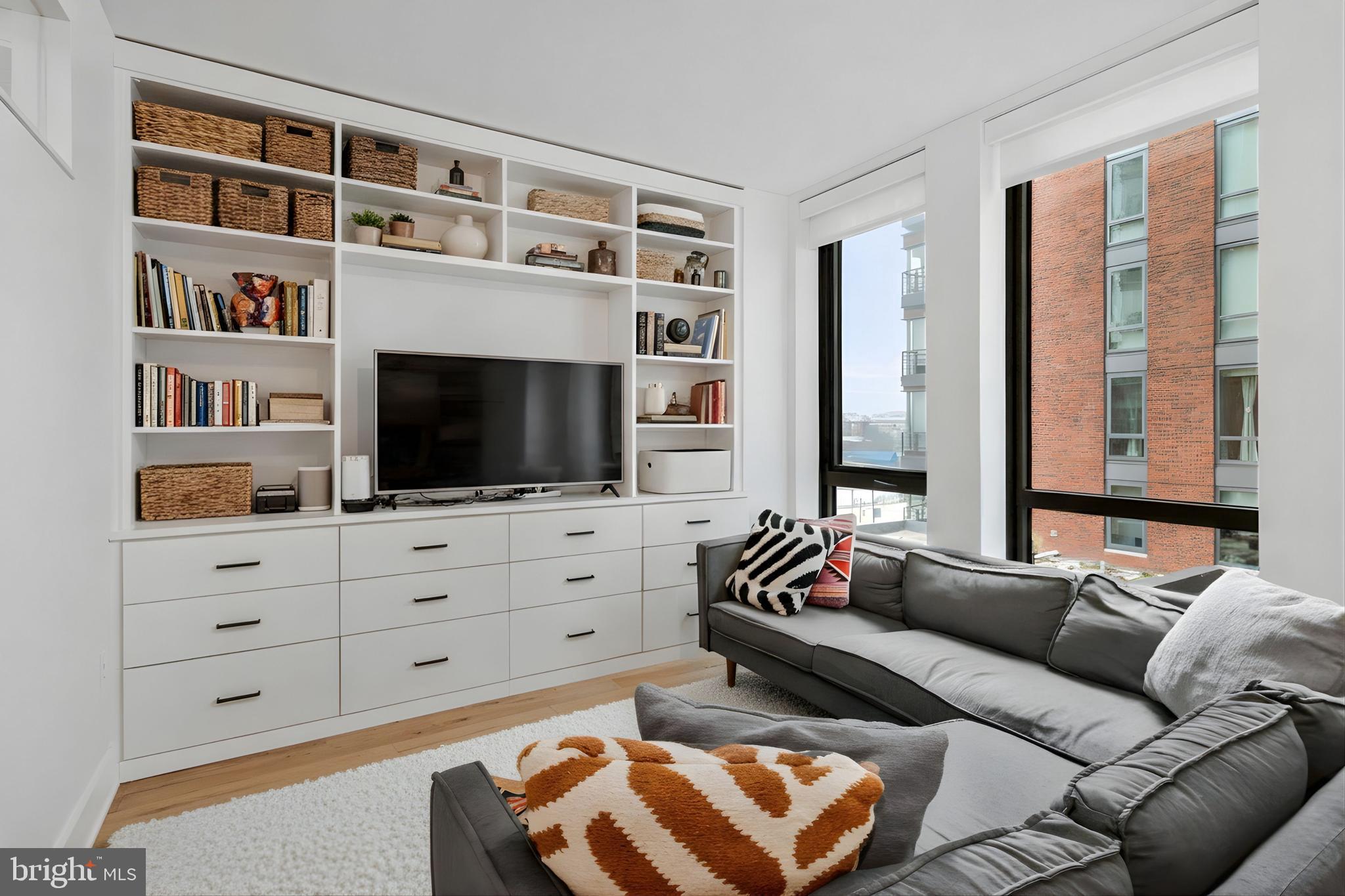 1211 Van Street Southeast, Unit 614 Washington, DC 20003 - Photo 3 of 21 a living room with furniture cabinets and a flat screen tv