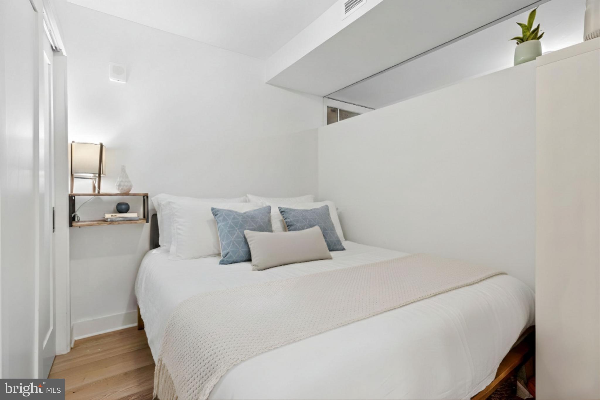 1211 Van Street Southeast, Unit 614 Washington, DC 20003 - Photo 5 of 21 a bedroom with a bed and a night stand