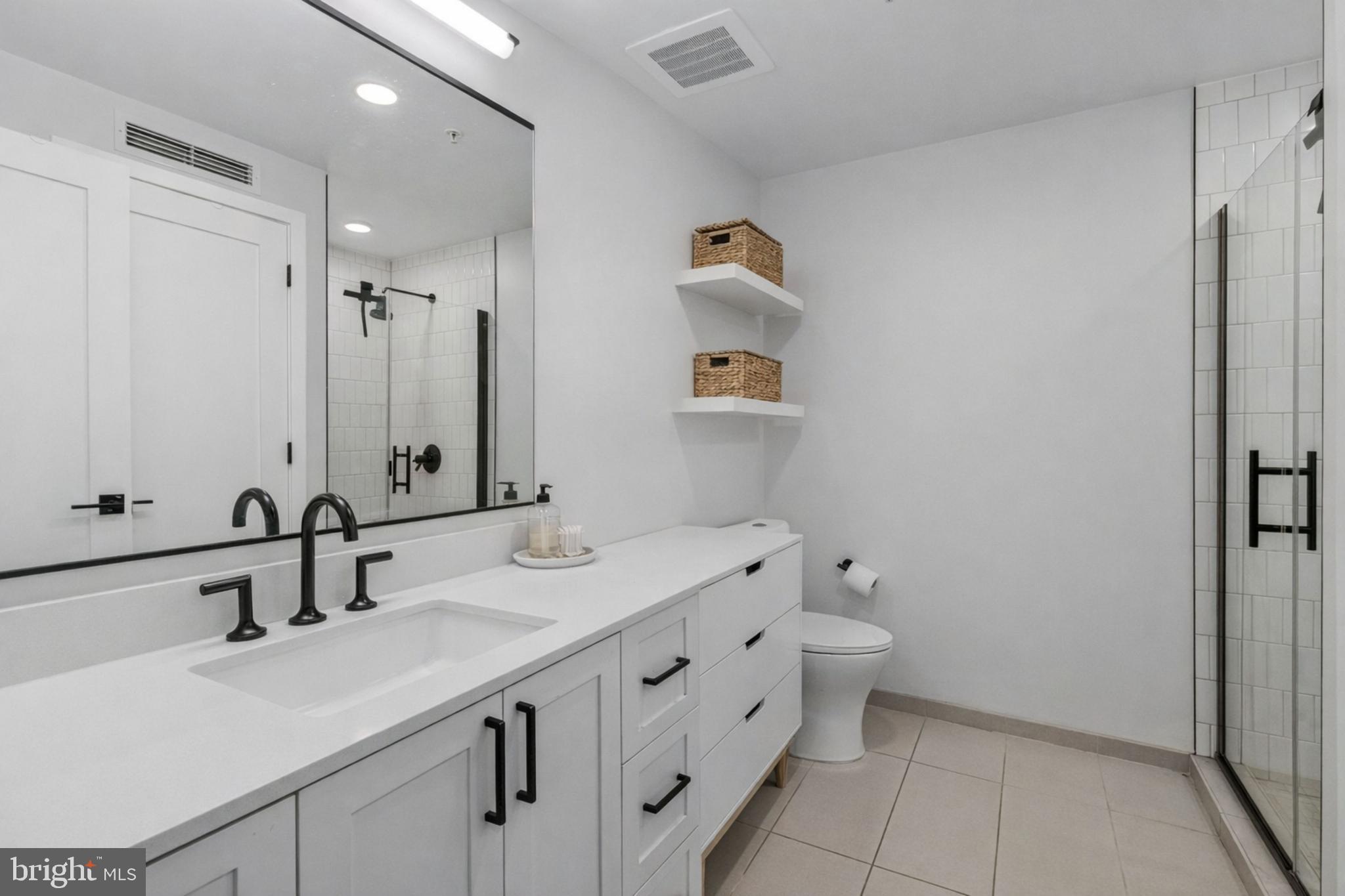 1211 Van Street Southeast, Unit 614 Washington, DC 20003 - Photo 6 of 21 a bathroom with a double vanity sink mirror and toilet