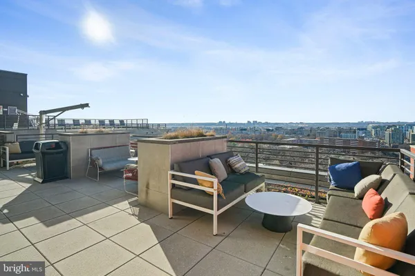a terrace with outdoor seating and city view