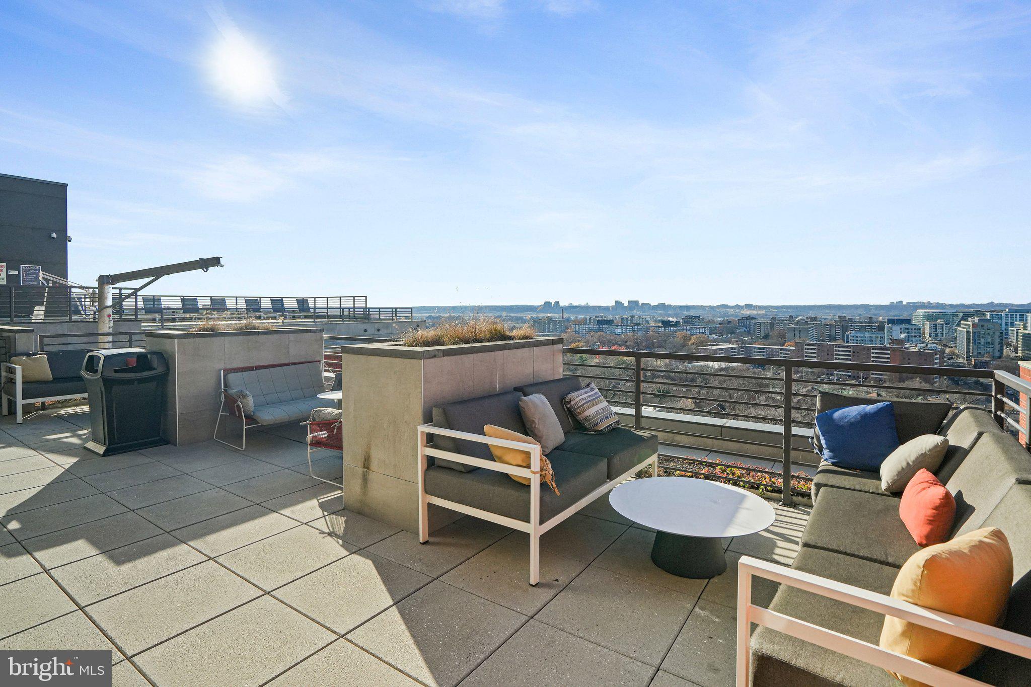 1211 Van Street Southeast, Unit 614 Washington, DC 20003 - Photo 9 of 21 a terrace with outdoor seating and city view