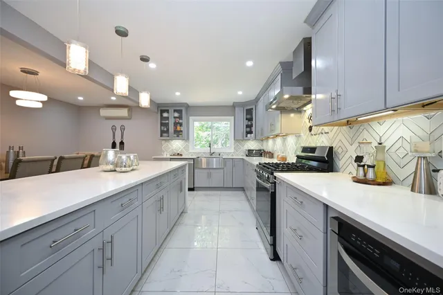 a large kitchen with stainless steel appliances lots of counter space sink and cabinets