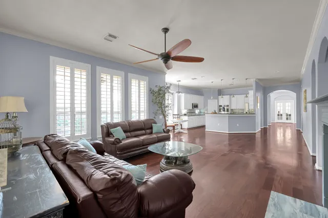 a view of a living room filled with furniture and a wooden floor