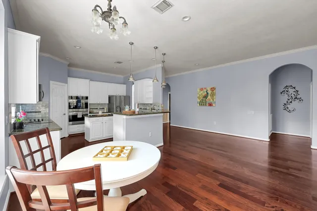 a kitchen with stainless steel appliances granite countertop a sink stove and cabinets