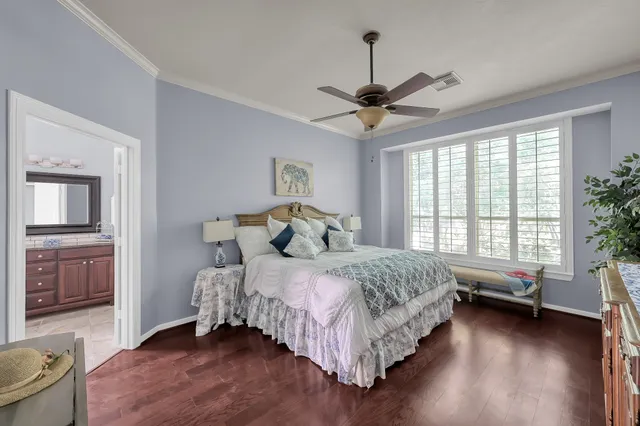 a bedroom with a bed and a potted plant