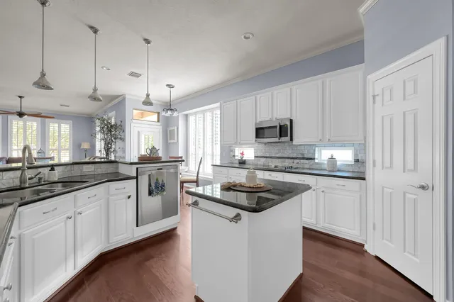 a bathroom with a sink mirror vanity and shower