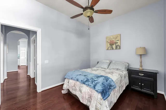 a bedroom with a bed and a chandelier
