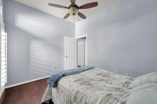 a bedroom with a bed a dresser and a window