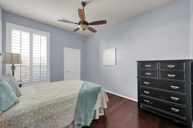 a bathroom with a granite countertop sink mirror vanity and toilet