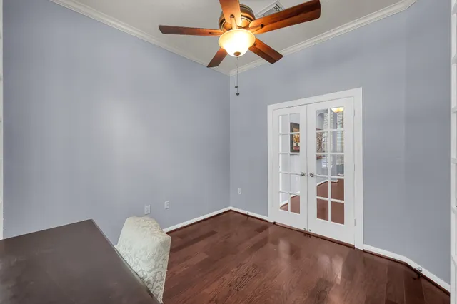 an empty room with a fan & a ceiling fan