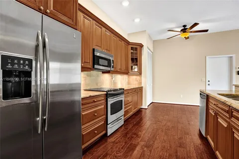 a kitchen with stainless steel appliances a refrigerator and a stove top oven