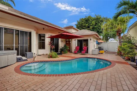 a view of a house with swimming pool and a patio