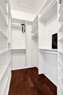 a view of walk in closet with empty racks