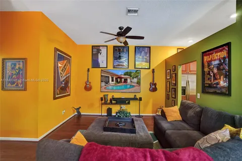 a living room with furniture and painting on the wall