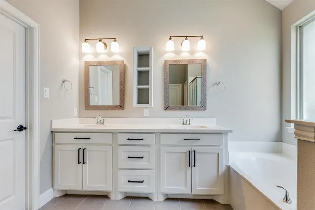 a bathroom with double vanity sinks and a mirror