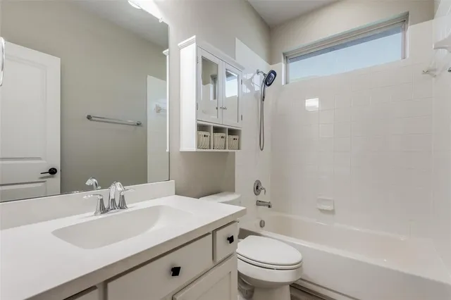 a bathroom with a sink toilet tub and shower