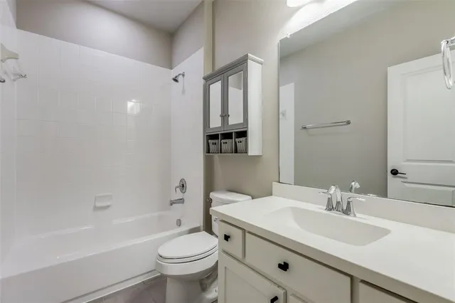 a bathroom with a sink toilet tub and shower