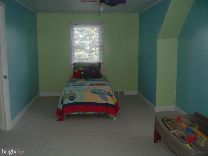 5553 Gayland Road Halethorpe, MD 21227 - Photo 10 of 12 a bedroom with a bed and window