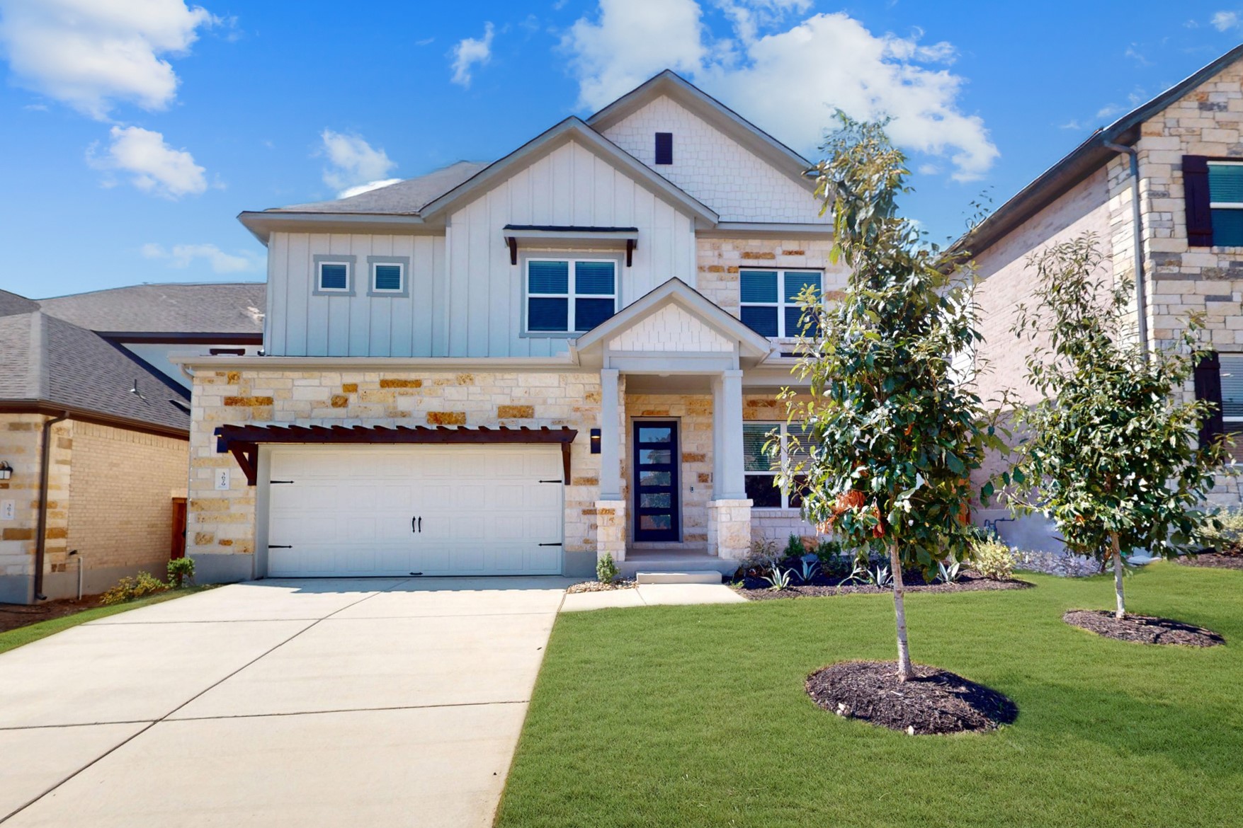 a front view of a house with a yard and garage