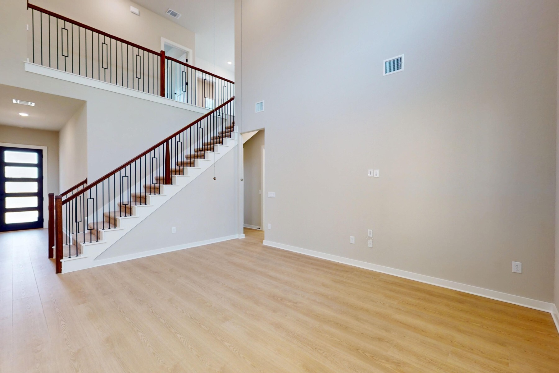 3679 Prosper Road Leander, TX 78641 - Photo 7 of 40 a view of staircase with wooden floor and white walls