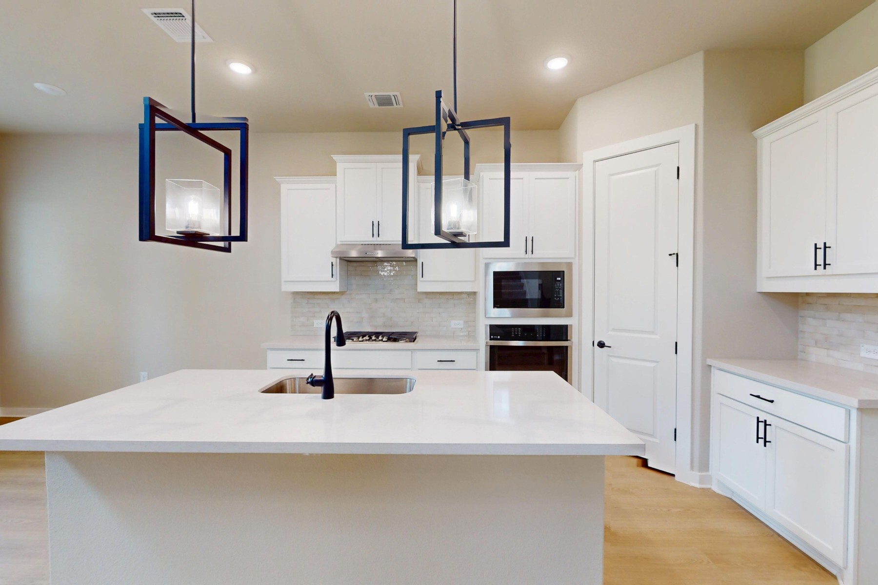 3679 Prosper Road Leander, TX 78641 - Photo 9 of 40 a kitchen with stainless steel appliances a sink and a refrigerator
