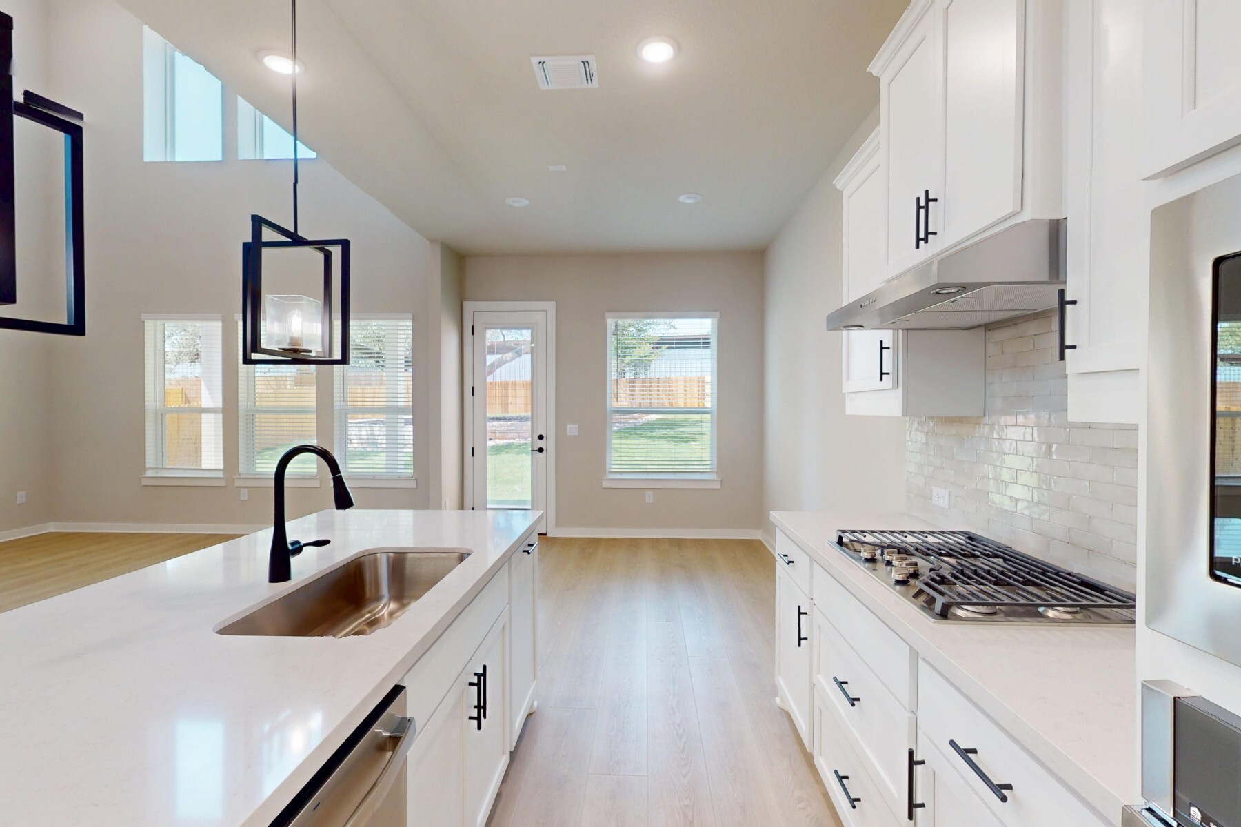 3679 Prosper Road Leander, TX 78641 - Photo 10 of 40 a kitchen with sink a stove and refrigerator