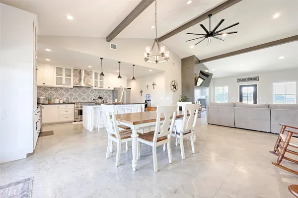 a kitchen with stainless steel appliances granite countertop a sink a stove and a refrigerator