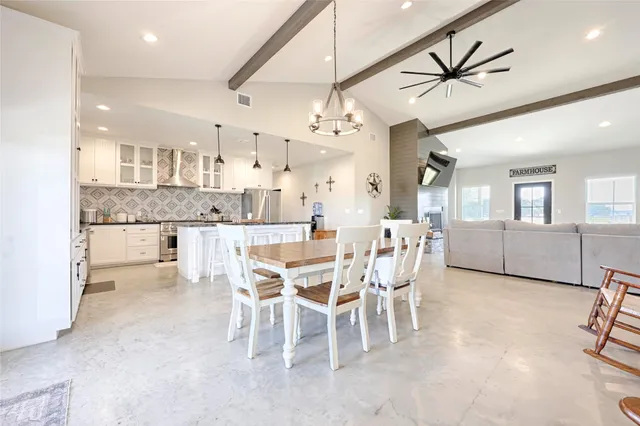 a kitchen with stainless steel appliances granite countertop a sink a stove and a refrigerator