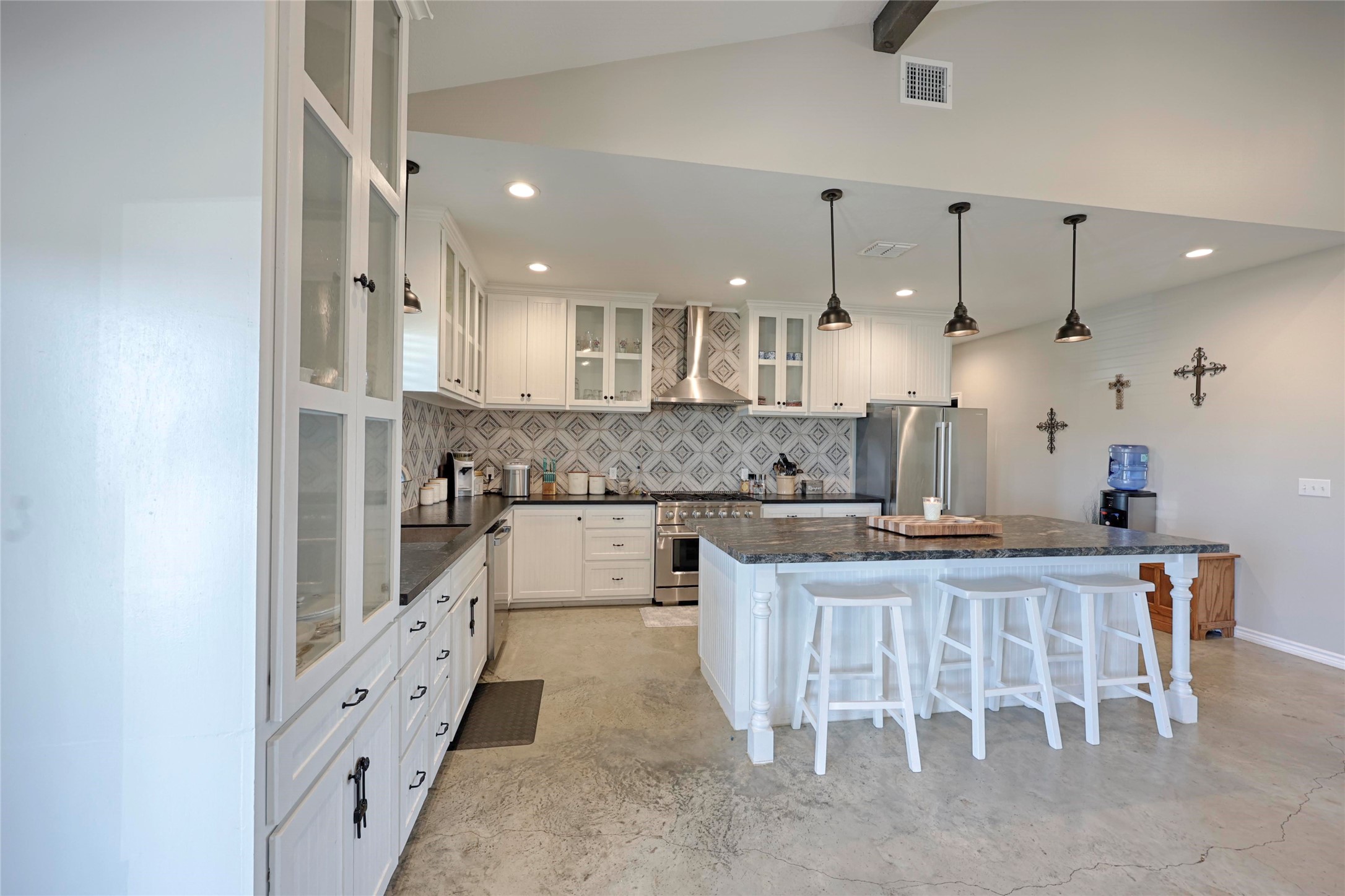 1100 Calhoun Road Eagle Lake, TX 77434 - Photo 19 of 48 a large kitchen with kitchen island white cabinets and stainless steel appliances