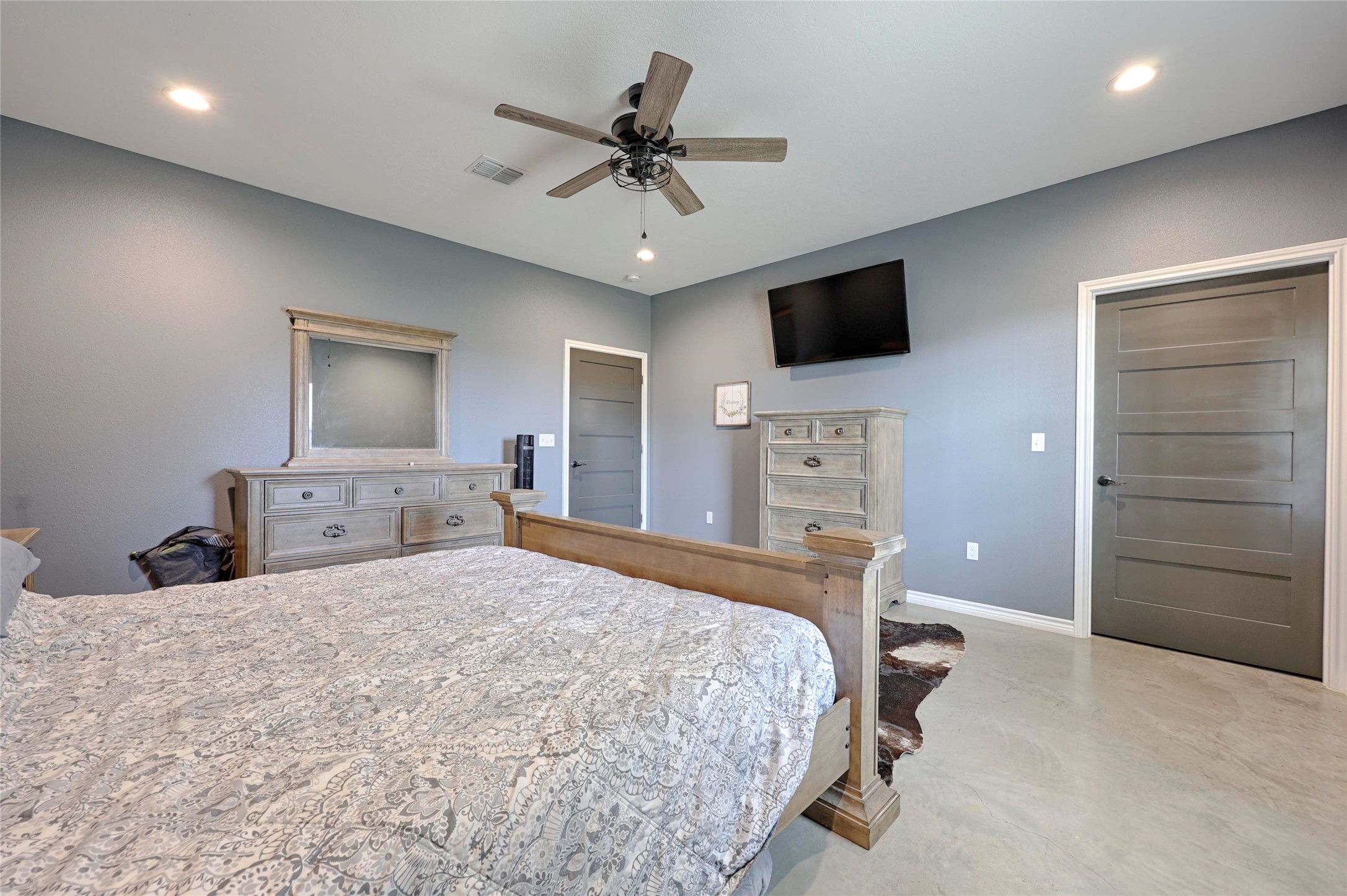 1100 Calhoun Road Eagle Lake, TX 77434 - Photo 27 of 48 a bedroom with a bed and a flat tv screen on dresser