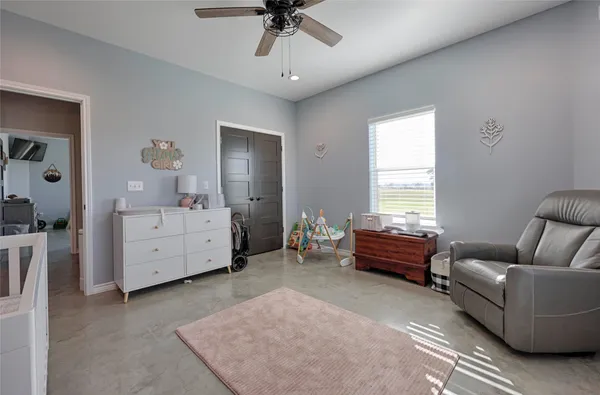 a bedroom with furniture and a window