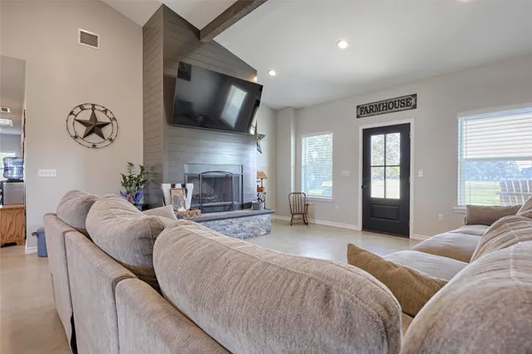 a living room with furniture and a chandelier