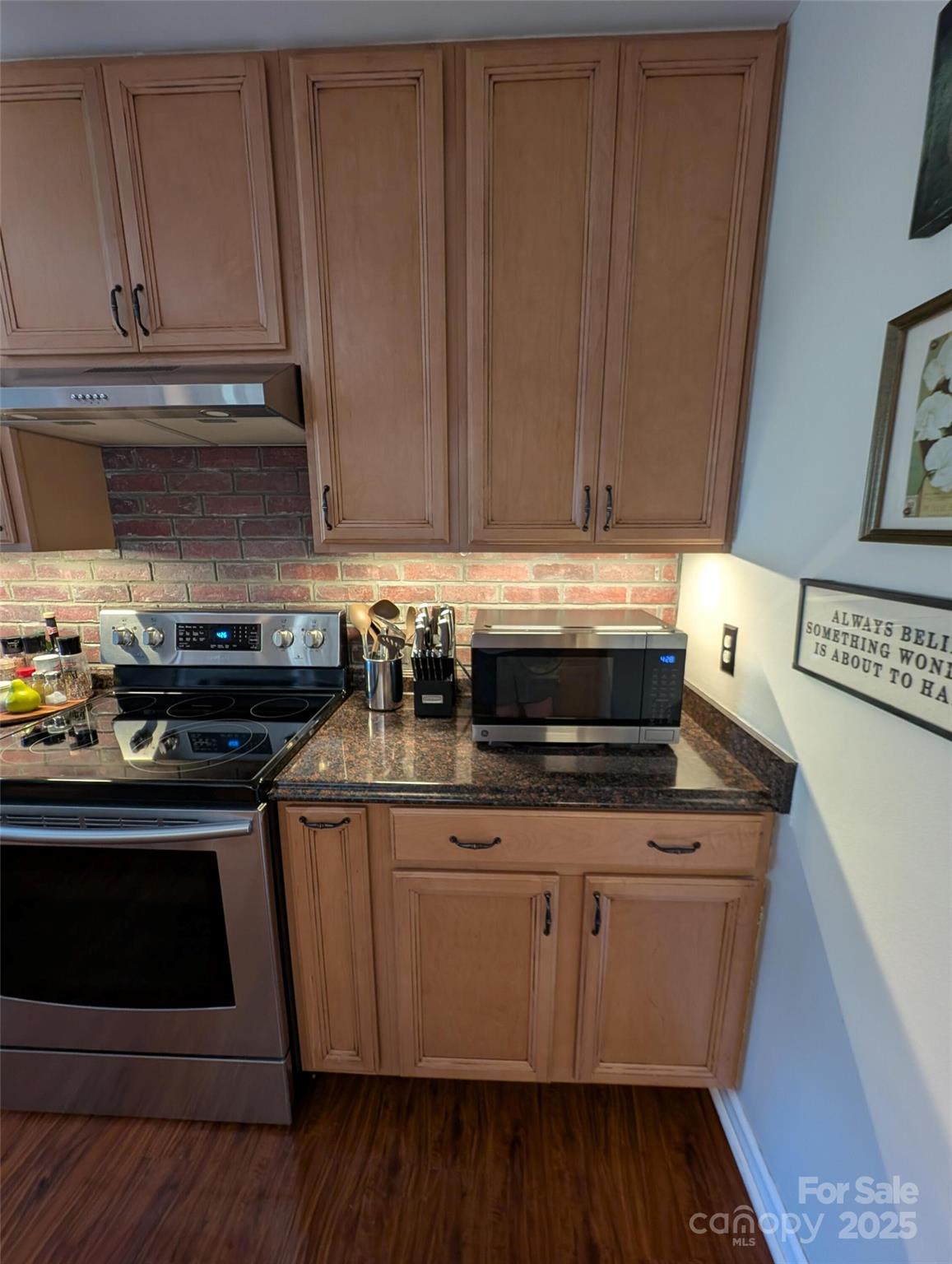 816 Maize Street Lexington, SC 29072 - Photo 21 of 34 a kitchen with granite countertop wood cabinets and a stove top oven