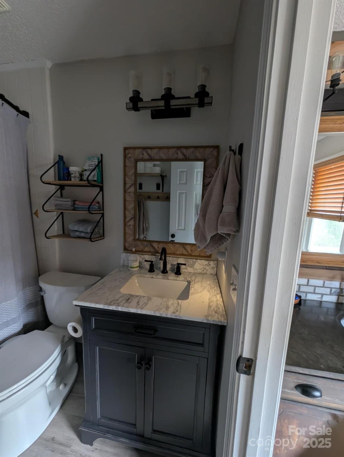 816 Maize Street Lexington, SC 29072 - Photo 25 of 34 a bathroom with a granite countertop sink vanity mirror bathtub and toilet