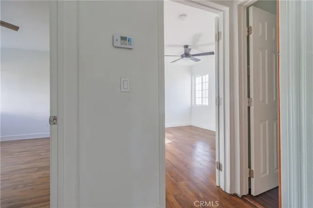 a view of a hallway with wooden floor